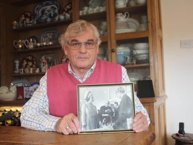 Mick Coxhead with the photo of himself at 17 meeting The Queen