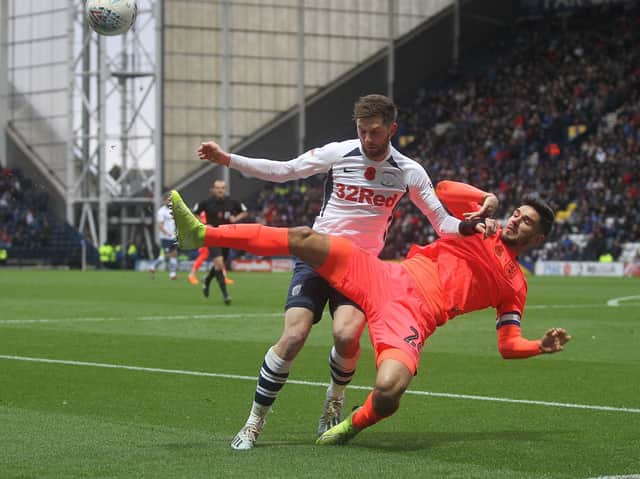 Preston winger Tom Barkhuizen competes for the ball against Huddersfield