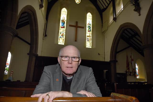 Rev Peter Smith at St Peter's Church, where fund-raising continues to save two stained glass windows and the bell tower (Image: JPIMedia)