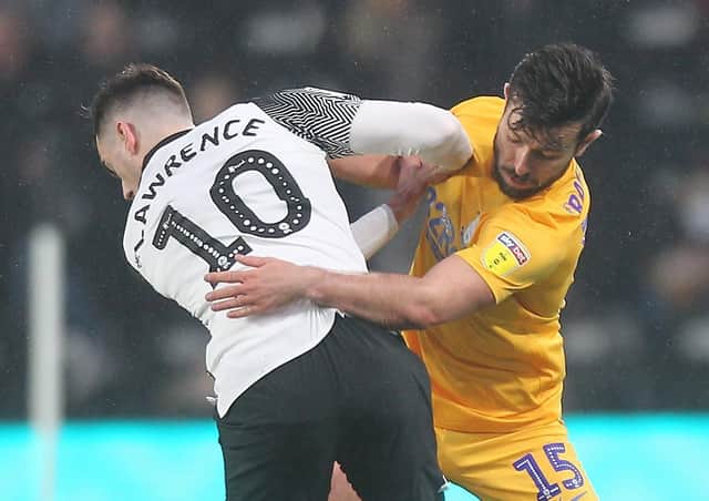 Joe Rafferty in action with Derby County's Tom Lawrence