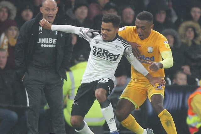 Darnell Fisher challenges Duane Holmes, watched by Preston manager Alex Neil