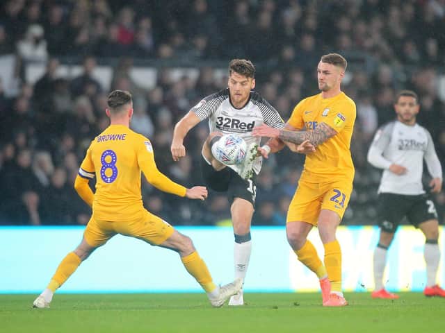 Alan Browne and Patrick Bauer challenge Chris Martin for possession at Pride Park.