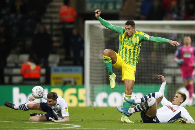 PNE duo Paul Huntington and Brad Potts slide in on West Brom's Jake Livermore at Deepdale