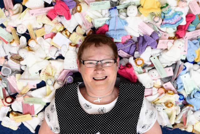 Mary Ryan is led down with all the angels knitted by the craft club at Bamber Bridge Methodist Church.