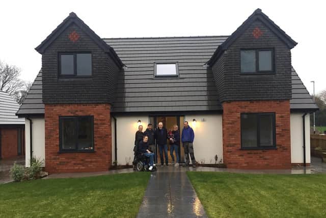 Andrew Bradshaw (centre) at the house he is offering up with some of the builders and Kirsty Cropper and Liam Batty (front left), who will be shifting through applications