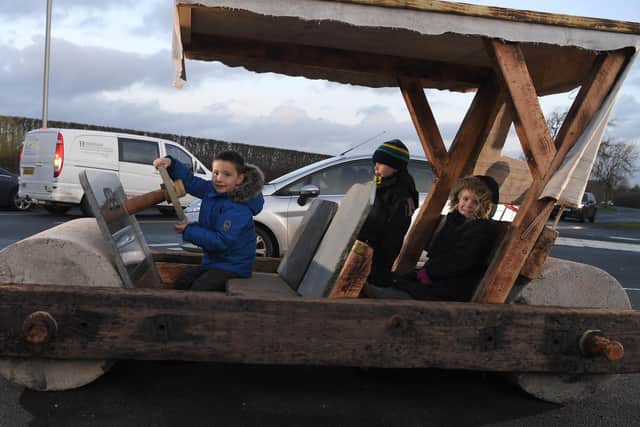 Max, Theodore and Madison in the Flintstones caveman car that has appeared in Walmer Bridge (Image: JPIMedia)