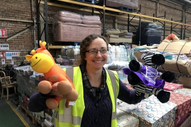 Julie Rowlandson, community ambassador for International Aid Trust, with some of the toys that have been donated to the organisation's Christmas gift appeal.