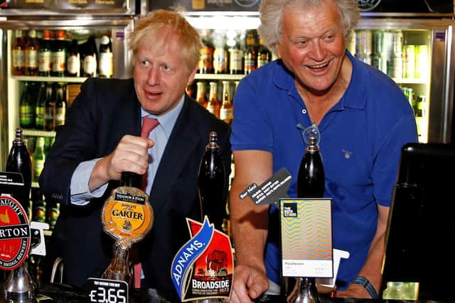 Tim Martin, Chairman of JD Wetherspoon (right), with Prime Minister Boris Johnson during a visit to Wetherspoons Metropolitan Bar in London.