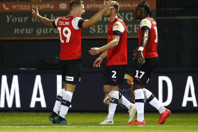 Luton striker James Collins celebrates with team-mates after scoring