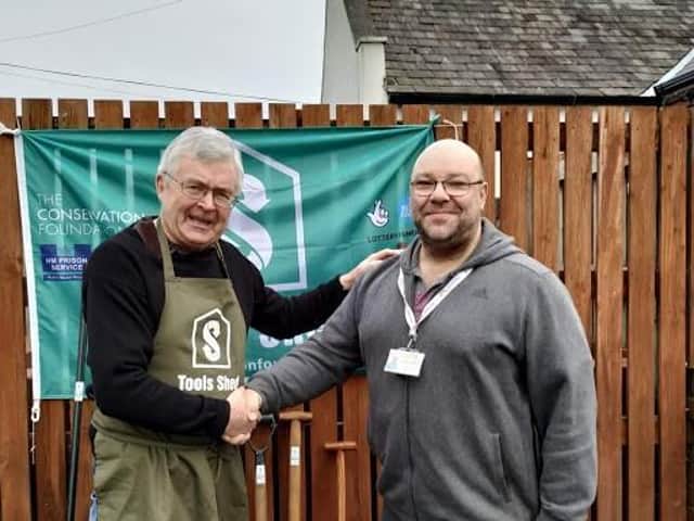 Anthony Concannon collects refurbished tools from Tools Shed regional coordinator Hugh Sloan