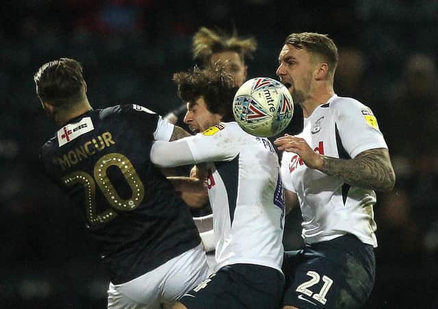 Ben Pearson challenges with Luton midfielder George Moncur at Deepdale, together with Patrick Bauer