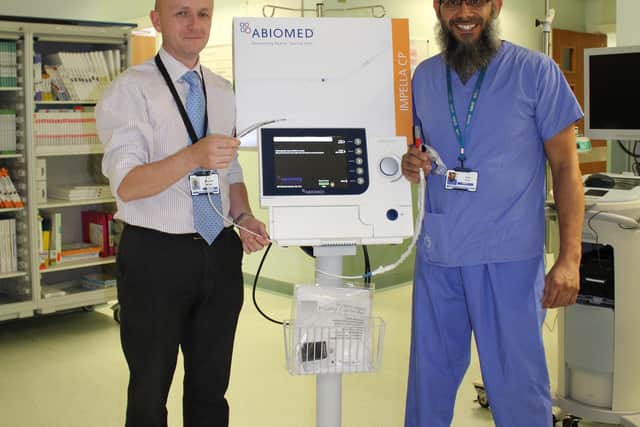 Dr Andrew Wiper and Dr Billal Patel with the heart pump at Blackpool Victoria Hospital