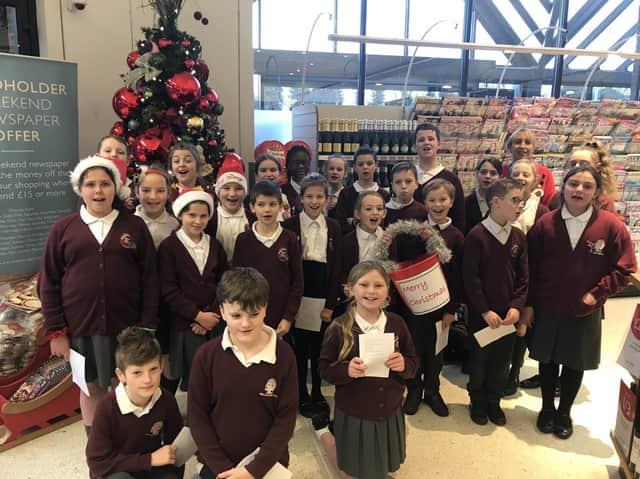 Broad Oak Primary choir sing to shoppers at Booths in Penwortham