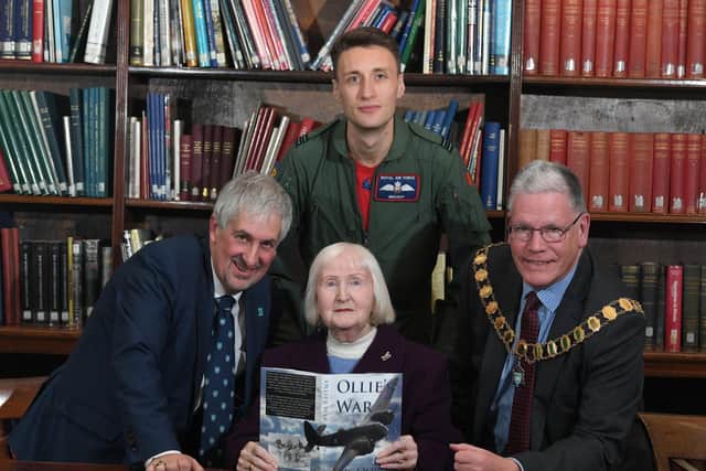 Joan presents copies of Ollie's War to the Harris Library, with ex-Mayor Trevor Hart (left), Flt Lt Arran Broad of the RAF and current Mayor Coun David Borrow.