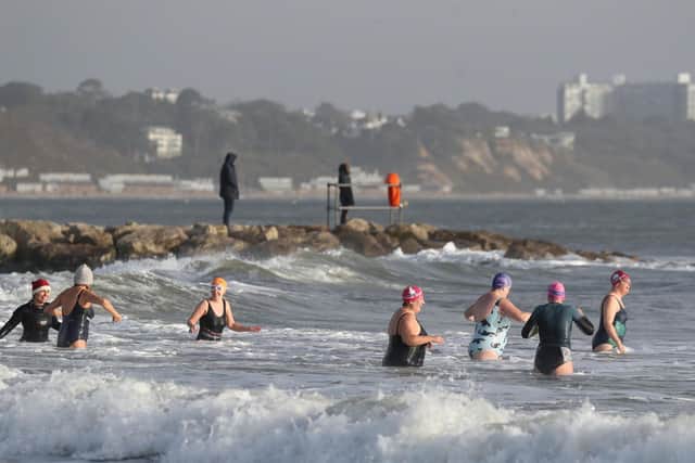 Member of the Beyond the Blue swimming group in the sea at Sandbanks Beach in Dorset, as they take part in a Christmas eve swim