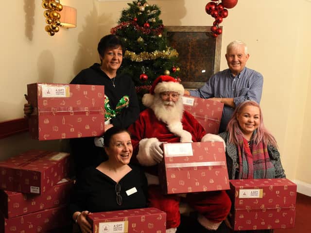 Natalie Bradford, of Key Group delivering Christmas hampers for residents of Sherwood Court, Fulwood, with Tony Holland, Lynn Cornwell, Liz Brotherton and Santa