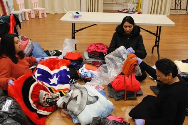 Volunteers at BAPS Shri Swaminarayan Mandir organising clothes and food they then donated to homeless charity Emmaus in Preston