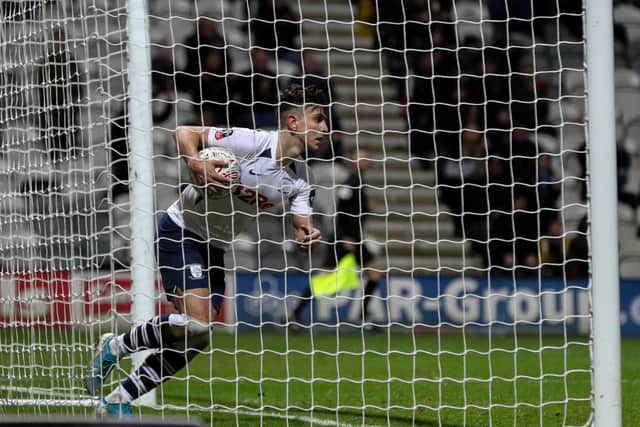 Josh Harrop collects the ball from the net after scoring Preston's second goal against Norwich