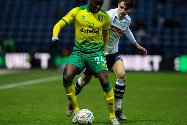 Norwich defender Ibrahim Amadou shields the ball from Preston midfielder Tom Bayliss at Deepdale