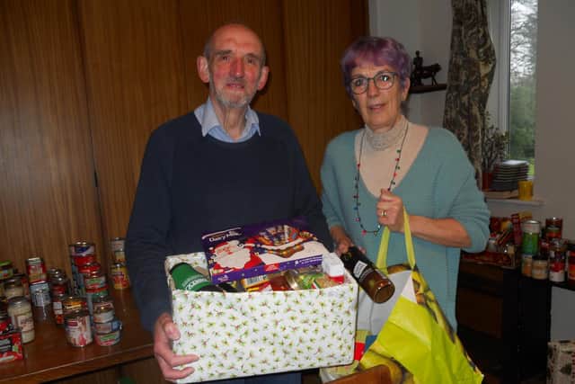 Farington Parish Coun Mike Otter, pictured with Barbara Bidwell, has been overwhelmed with Christmas donations to St Marys Church food bank