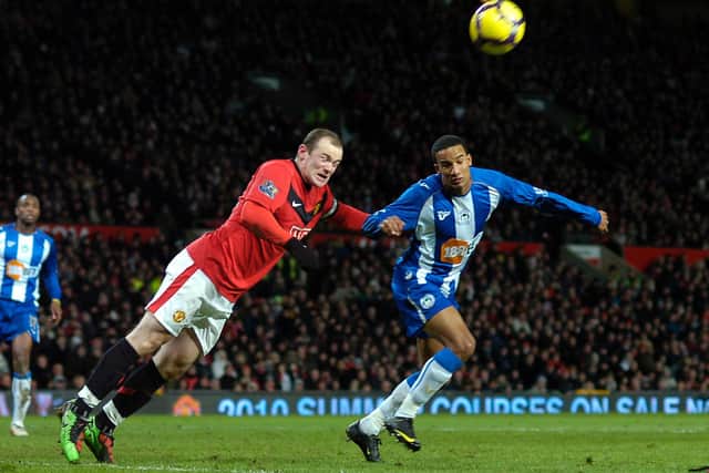 Scott Sinclair challenges with Wayne Rooney playing for Wigan against Manchester United