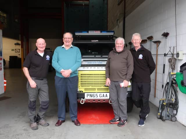 Tony Harrison with Bowland and Pennine Mountain Rescue Team members Ian Maddison (far left) and Paul Durham (far right) and Norwest Fellwalking Club secretary David Johnstone.