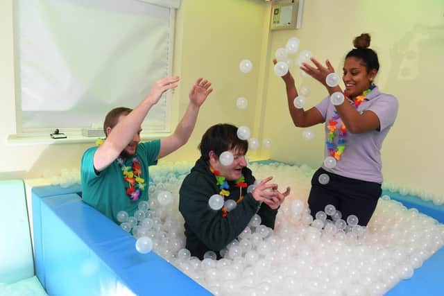Michael in a ball pit with Prisha Patel and Arron Taylor