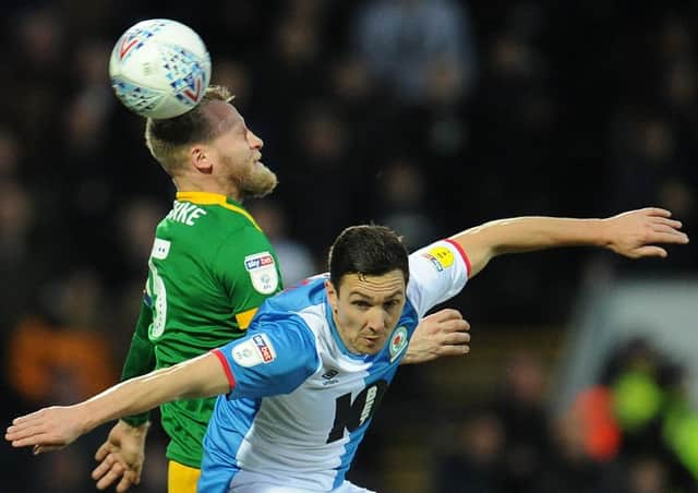 Preston North End captain Tom Clarke battling Blackburn's Stewart Downing