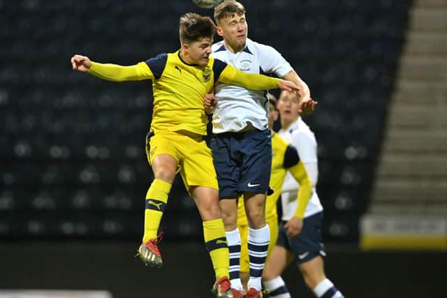Preston midfielder Brian McManus challenges in the air against Oxford    Pic: courtesy of PNE