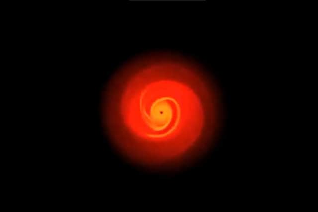 Computer simulation of planets forming in a protoplanetary disc around a red dwarf star.