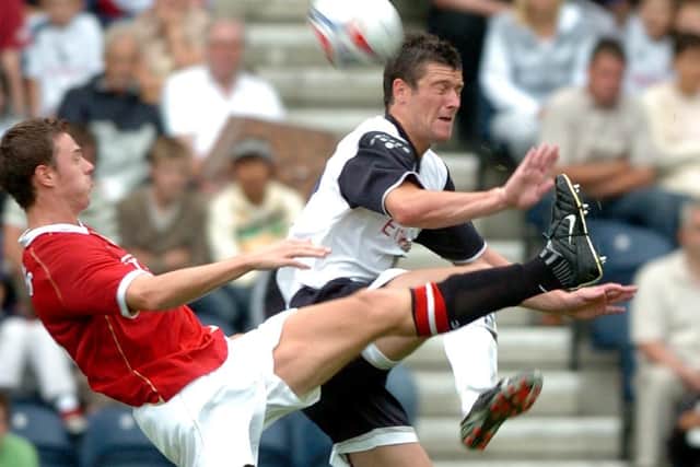 David Nugent is challenged by Jonny Evans in Preston's pre-season friendly against Manchester United in July 2006