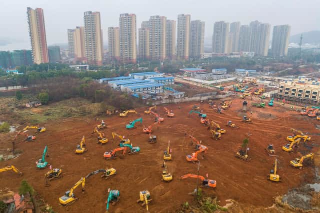 Excavators at the construction site of a new hospital being built to treat patients from a deadly virus outbreak in Wuhan in China's central Hubei province (Photo by STR/AFP via Getty Images)