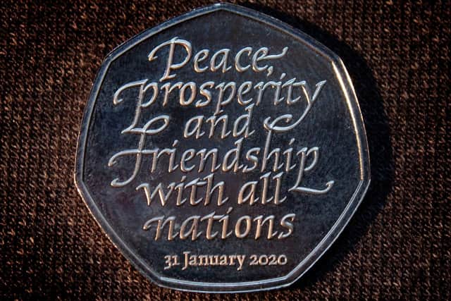 The new Brexit coin, a 50p bearing the inscription 'Peace, prosperity and friendship with all nations' and the date the UK leaves the EU.