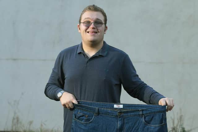 Daniel with an old pair of trousers. He used to weigh 24 stone