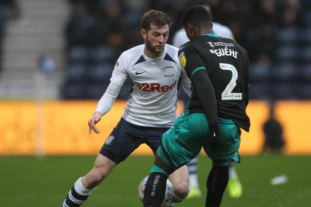 Preston's Tom Barkhuizen takes on Swansea defender Marc Guehi
