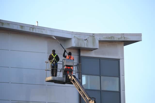 Workmen use a jet wash to clean the outside of a block at Arrowe Park Hospital in Merseyside, where British nationals from the coronavirus-hit city of Wuhan in China are being quarantined.