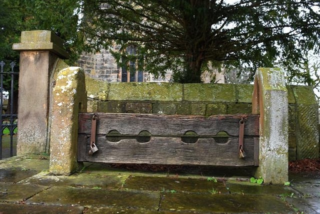 Village stocks, probably 18th century, restored 1902 to commemorate coronation of Edward VII