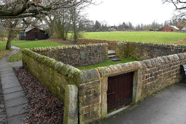 Pinfold, probably C18. Roughly-squared sandstone blocks, built to house animals found straying from their owners land or grazing somewhere without the necessary rights