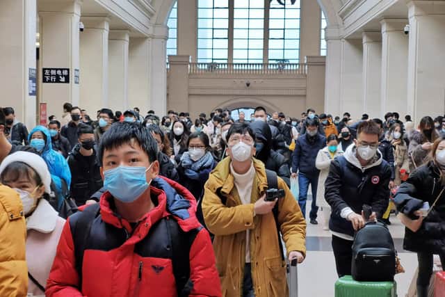People wear face masks as they wait at Hankou Railway Station on January 22, 2020 in Wuhan, China. A new infectious coronavirus known as "2019-nCoV" was discovered in Wuhan last week. Health officials stepped up efforts to contain the spread of the pneumonia-like disease which medical experts confirmed can be passed from human to human. Cases have been reported in other countries including the United States,Thailand, Japan, Taiwan, and South Korea. It is reported that Wuhan will suspend all public transportation at 10 AM on January 23, 2020. (Photo by Getty Images)