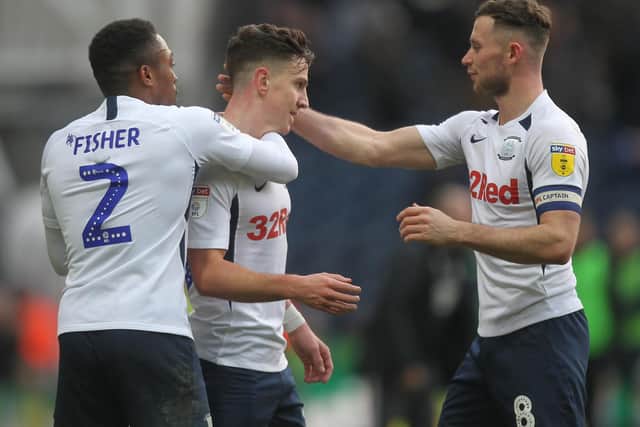 Josh Harrop is congratulated by PNE team-mates Darnell Fisher and Alan Browne