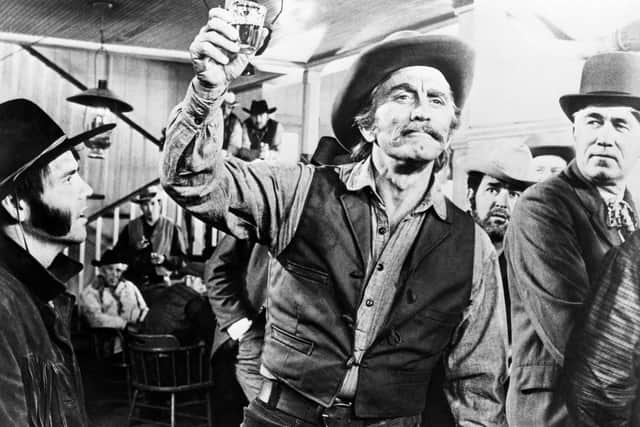 Kirk Douglas in a scene from the film A Gunfight, in which he takes part in a duel in a Mexican village.