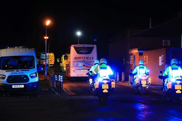 The first 83 Britons arrive at Arrowe Park Hospital on chartered coaches escorted by police on Friday, January 31. Pic: Getty