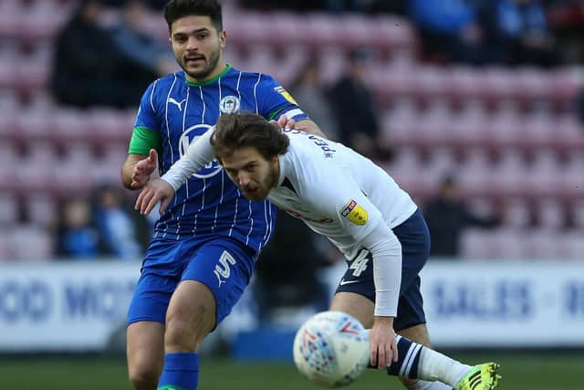 PNE midfielder challenges with Wigan's Sam Morsy