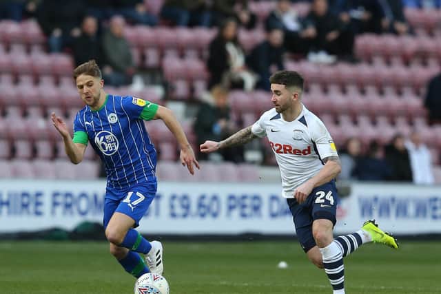 Preston striker Sean Maguire competes with Wigan substitute Michael Jacobs