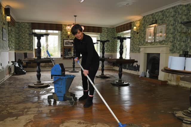 Ribchester Arms manageress Samantha Hubbard begins the clean-up