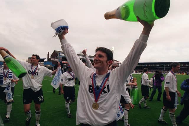 Jon Macken celebrates Preston North End's championship after the game against Millwall