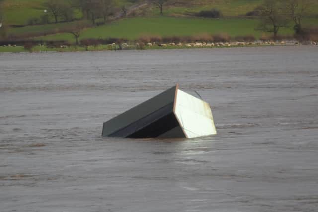 A shed from the local allotments floats down the river Ribble (photo Alan Tomlinson)