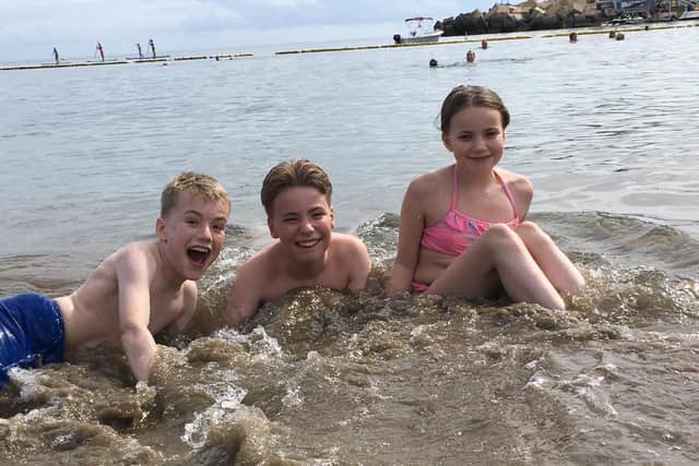 Joel Shaw (left) with siblings Jake and Jasmine on holiday in Gran Canaria prior to beginning treatment