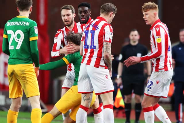 Ben Pearson (centre) reacts to a challenge at Stoke – and ended up in the book