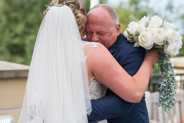 A hug for the bride from her dad. The wedding of Conor and Katie Holgate